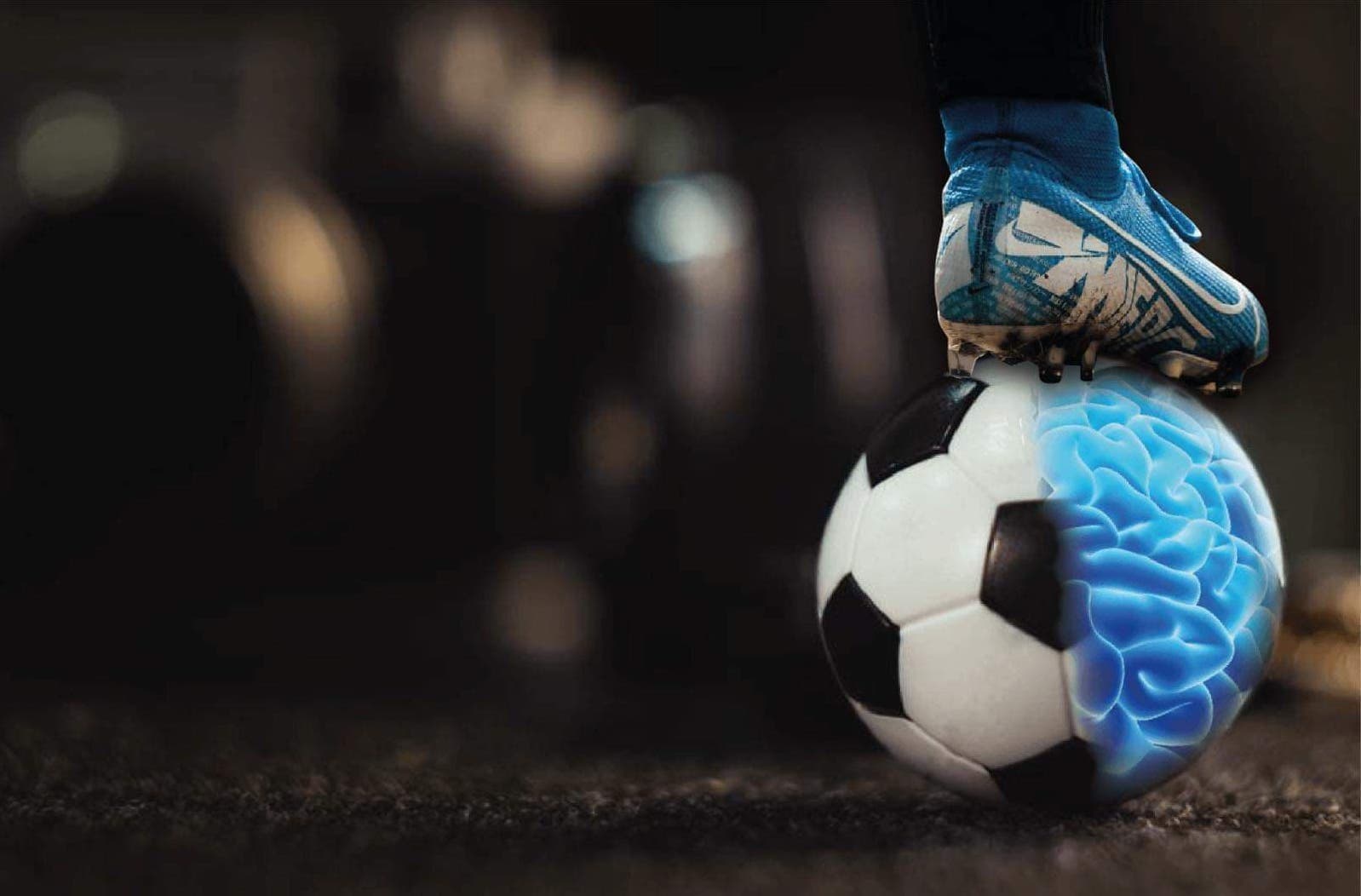 Close-up shot of a football boot resting on top of a football, half of the football looks like a brain.